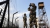 Indian Border Security Force soldiers patrol the fence alone the India-Pakistan border. (file photo)