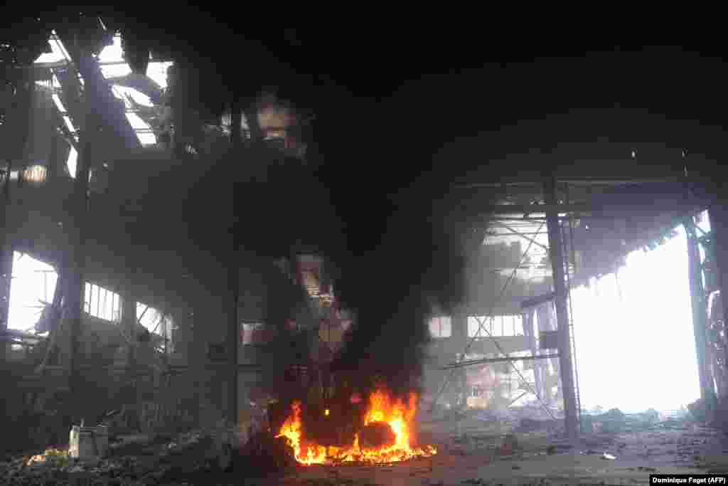 A vehicle burns inside the airport in October 16. Amid close-quarter fighting for control of the facility throughout late 2014 until early 2015, the airport was reduced to rubble as Russian-backed forces eventually regained control. 