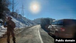 Nagorno Karabakh - A Russian peacekeeper stands guard on a blocked road leading to Armenia, December 12, 2022.