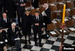 Președintele Franței, Emmanuel Macron, și prima doamnă a țării, Brigitte Macron, în timpul serviciilor funerare de la Westminster Abbey din centrul Londrei, 19 septembrie 2022.