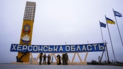 Пожежники стоять перед вагоном пасажирського потяга, пошкодженого внаслідок російського удару по Херсону, 3 травня 2023 року