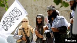 FILE: Taliban fighters during a brief cease-fire in Ghanikhel district of Nangarhar Province in June 2016.