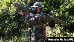 A Hizballah fighter holding an Iranian-made antiaircraft missile (file photo)