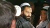 A newly freed Taliban prisoner hugs his relatives outside Bagram Prison, north of Kabul, on April 8.
