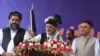 Ashraf Ghani (C), Afghan incumbent president and presidential candidate, stands with Amrullah Saleh (R), his vice presidential candidate, during his election campaign in Jalalabad on September 20.