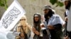 FILE: Taliban celebrate ceasefire in the eastern province of Nangarhar in June. 