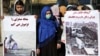 FILE: Afghan women activists hold banners highlighting alleged Taliban atrocities. 