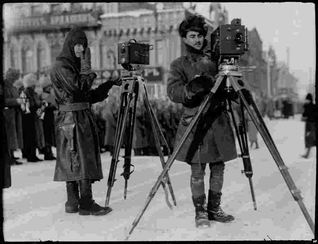 Дональд Томпсон (ліворуч), фотограф Leslie’s Weekly (ілюстрований щотижневий журнал Френка Леслі «Тижневик Френка Леслі», виходив у США від 1852 до 1922 року), і людина, названа як капітан Армії США Кінґмор, фільмують у Єкатеринбурзі на сході Росії при мінусовій температурі, близько 1919 року