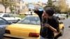 Un șofer de taxi iranian se răcorește în căldura extremă de la Teheran, iulie 2025. 