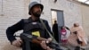 Pakistani security officials protect health workers as they administer Polio vaccination to children in Peshawar last month.