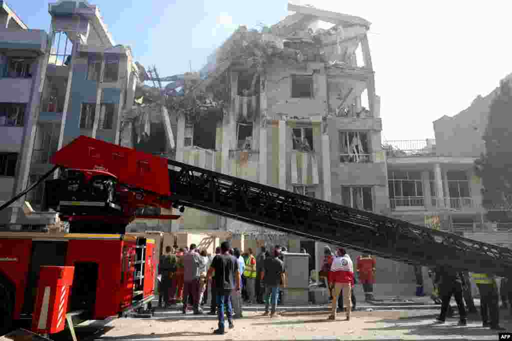 Rescue teams work outside a building targeted by an Israeli strike in the Iranian capital.